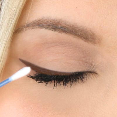 Dip a cotton bud in some eye cream to remove any mistakes